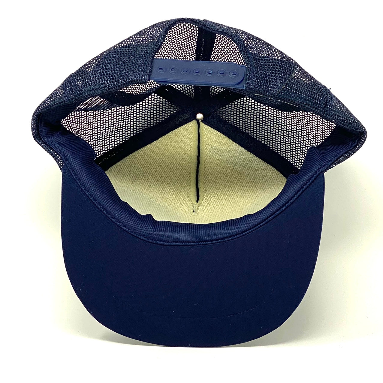 Bottom-inside view of navy blue vintage 90’s NASA Kennedy Space Center Snapback Trucker Hat with Felt Image.